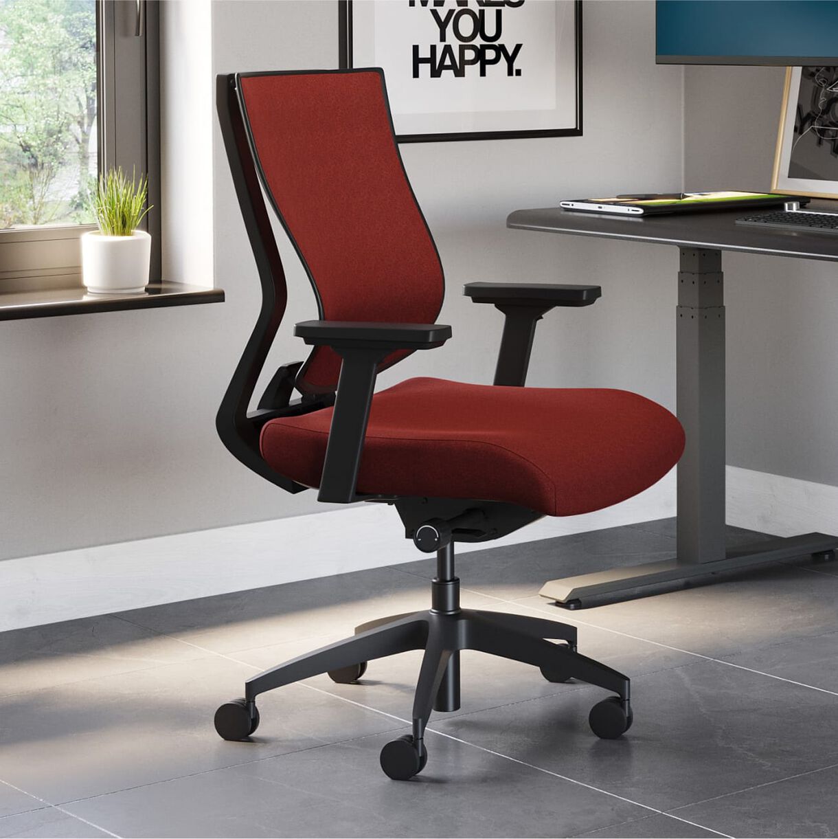 red task chair in front of a electric standing desk 